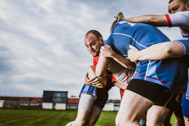 istock Aggressive rugby player making an effort while trying to pass his rivals on a match. 1177897070