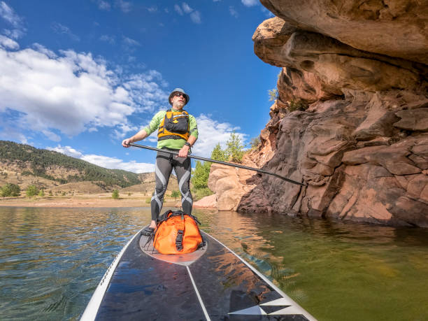 istock senior man paddling a stand up paddleboard 1177897328