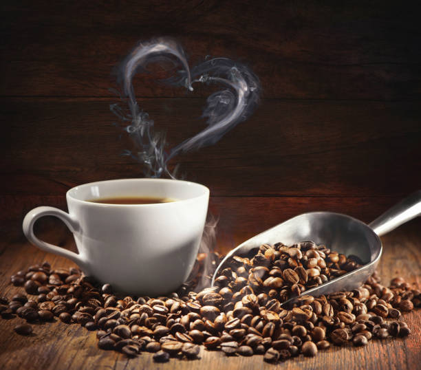 Coffee cup and coffee beans with bag, scoop and steam