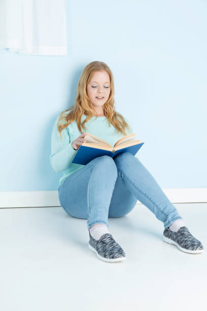 istock Blonde lady in her 20s reading a book 1177903852