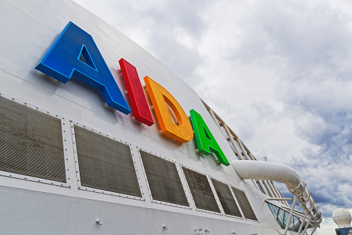 Kiel, Germany - August 10, 2019: Close-up of Aida logo from colorful letters on the side of a cruise ship.