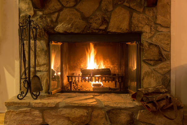 istock Closeup of a glowing fire in a stone fireplace. 1177904995