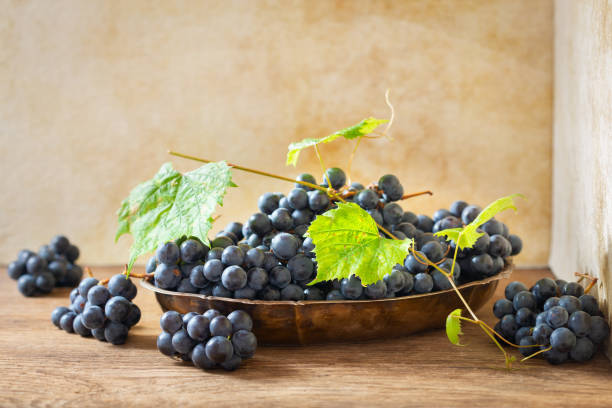 istock fresh ripe grapes with leaves in a bowl 1177905066