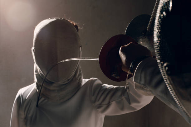 istock Fencer with fencing sword. Fencers duel concept. 1177906086