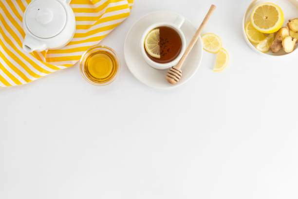 istock Black tea with lemon and honey on a white background. Hot tea cup isolated, top view flat lay. Flat lay. Autumn, fall or winter drink. Copy space. 1177906136