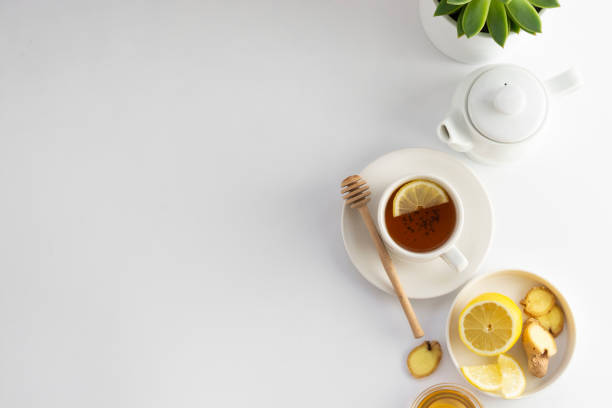 istock Black tea with lemon and honey on a white background. Hot tea cup isolated, top view flat lay. Flat lay. Autumn, fall or winter drink. Copy space. 1177906141