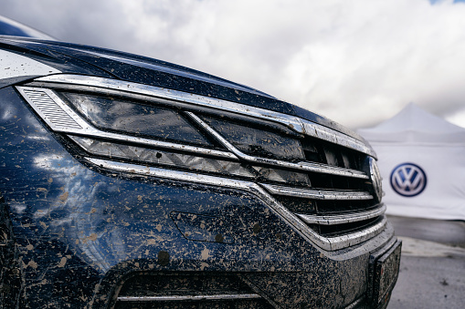 Minsk, Belarus - September 20, 2019: Closeup dirty headlight of Volkswagen Touareg Third generation 2019 after off road trip