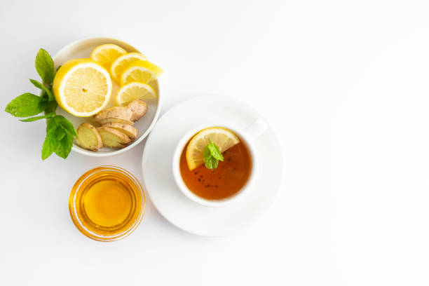 fresh tea with lemon and honey on a white background. hot tea cup isolated, top view flat lay. flat lay. autumn, fall or winter drink. copy space. - ginger tea cup cold and flu tea imagens e fotografias de stock