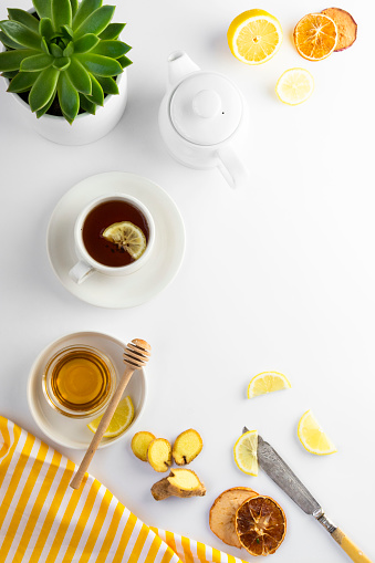 Ginger tea with lemon honey hot autumn, winter drink white background with copy space for text flat lay.