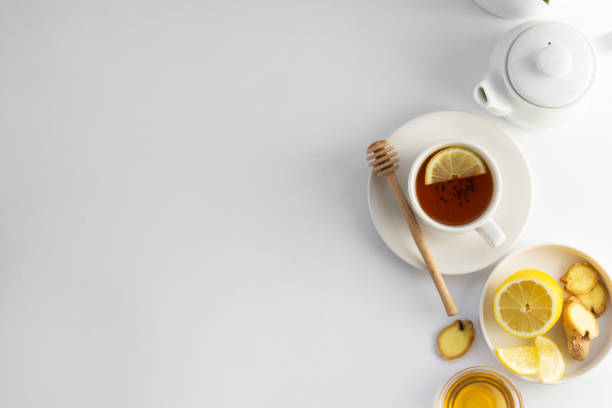 istock Black tea with lemon and honey on a white background. Hot tea cup isolated, top view flat lay. Flat lay. Autumn, fall or winter drink. Copy space. 1177906336
