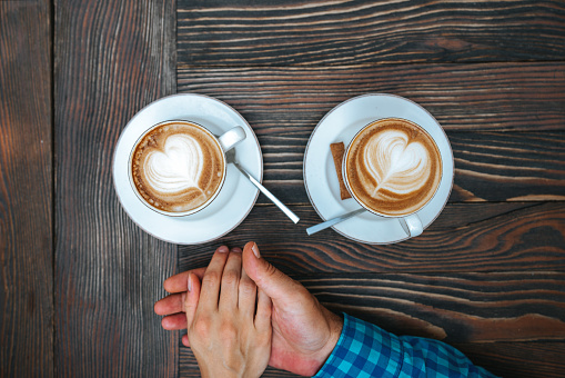 young couple in love drinking coffee on dating