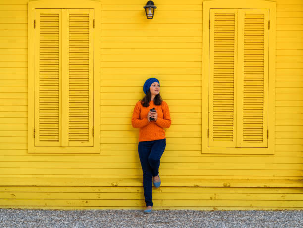 Young woman drinks coffee with blue beret outdoor