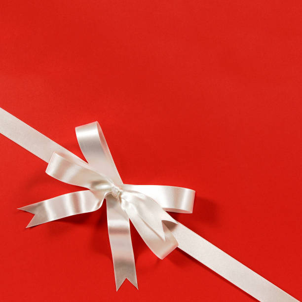 istock White gift bow ribbon red paper background corner diagonal 1177907610