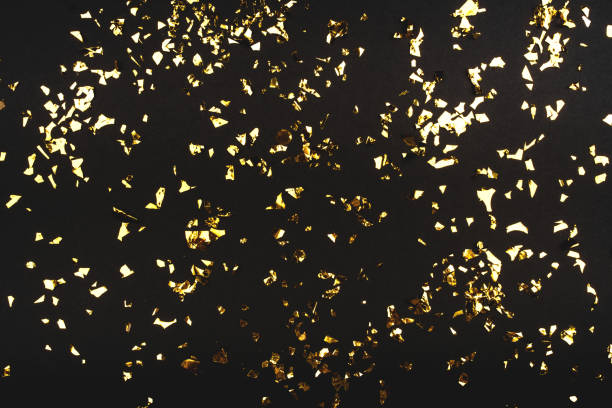 istock Gold confetti on black background. 1177909230