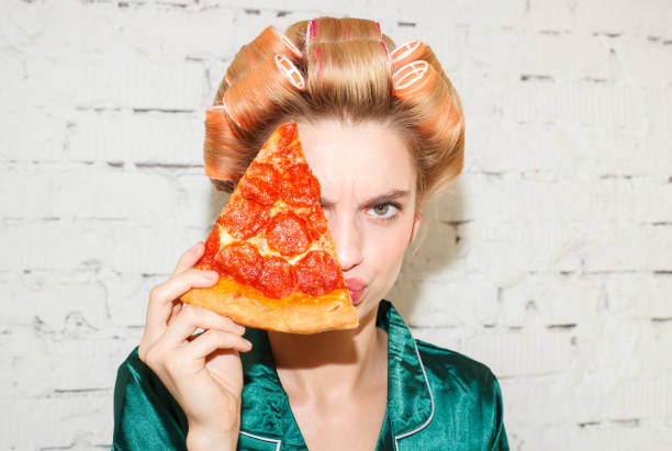 istock woman with pizza slice close up 1177909511