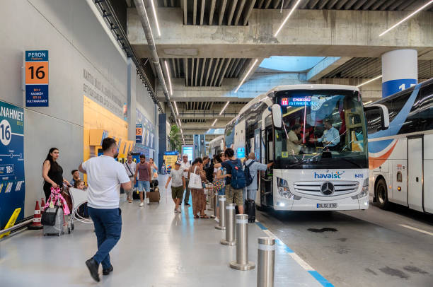 people get into a bus on the lower floor of the terminal at the new airport - bus station imagens e fotografias de stock