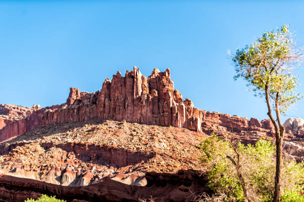 istock Fluted Wall butte mesa cliff low angle view in Capitol Reef National Monument with red shapes formations on canyon in Utah 1177910910
