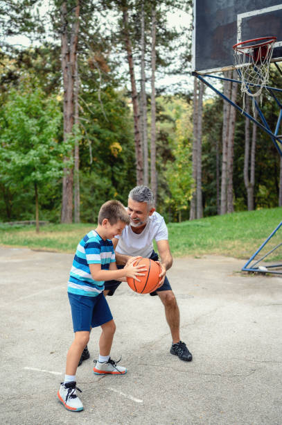 istock Father and son playing basketball 1177912045
