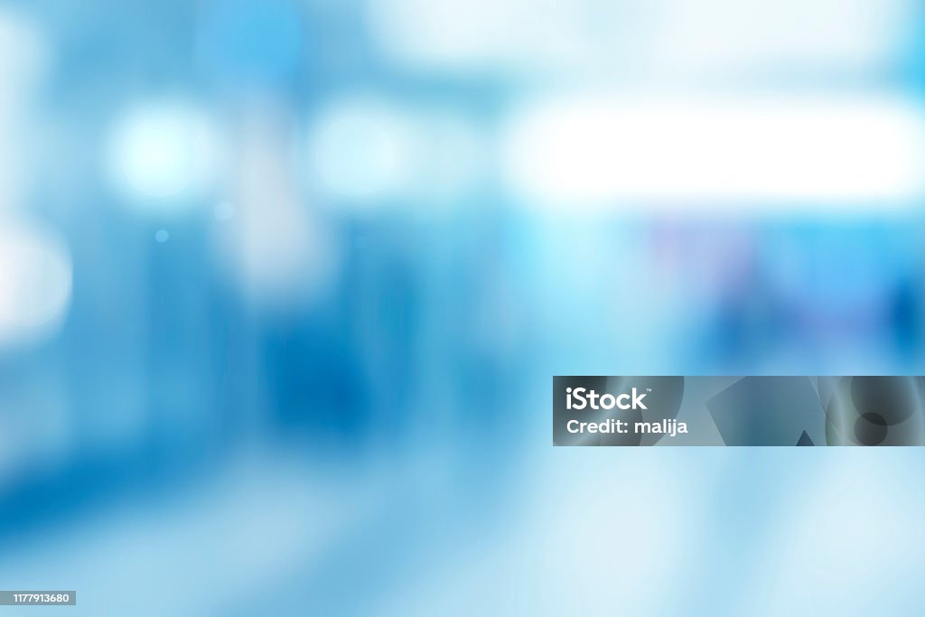 Abstract blurred interior of corridor clinic background in blue color , blurry image abstract defocused blurred technology space background, empty business corridor or shopping mall. Medical and hospital corridor defocused background with modern laboratory (clinic) Backgrounds Stock Photo