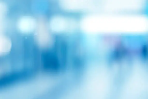 Photo of Abstract blurred interior of corridor clinic background in blue color , blurry image