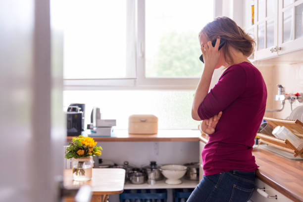 istock A young woman at home using a telephone 1177913809