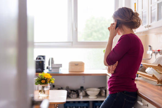 istock A young woman at home using a telephone 1177913826