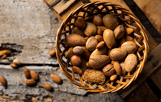 Healthy nuts mix in a wooden bowl top view