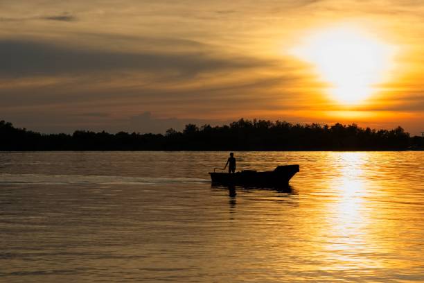 istock sunset and the boat silhouette 1177915011
