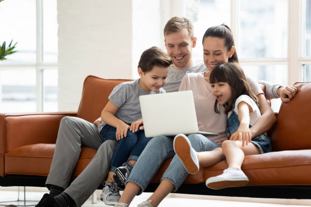 istock Happy family enjoy using laptop make online call at home 1177916007