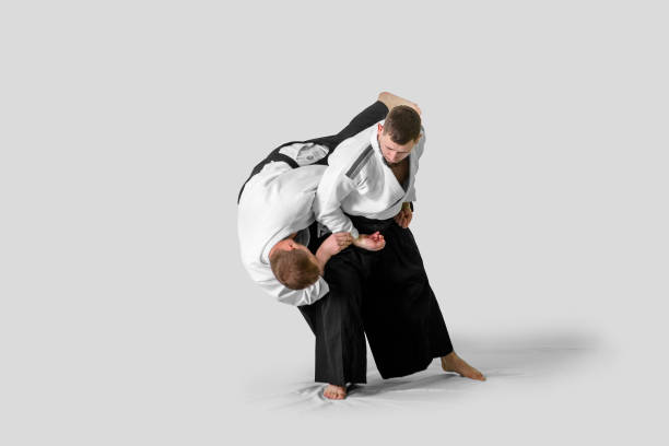 istock Two caucasian men are practicing aikido on the tatami (isolation path included) 1177916467