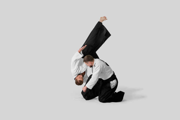 istock Two caucasian men are practicing aikido on the tatami (isolation path included) 1177916524