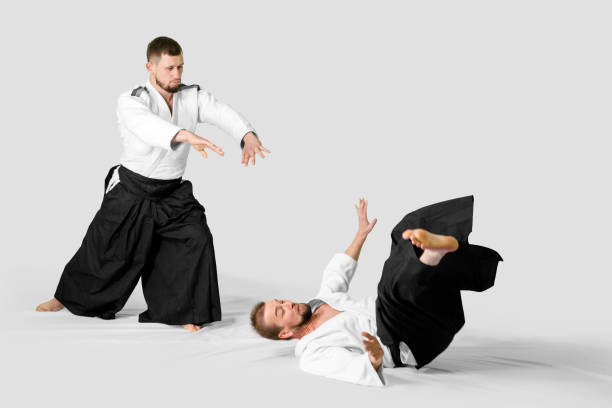 istock Two caucasian men are practicing aikido on the tatami (isolation path included) 1177916546