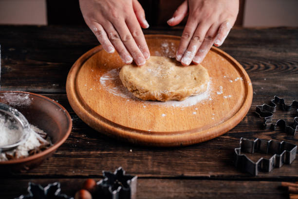 istock Woman kneading gingerbread dough on pastry board 1177917240