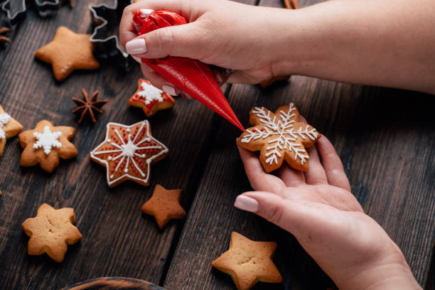 istock Woman decorating Christmas gingerbread cookies 1177917401