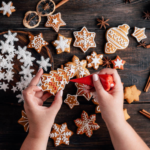 istock Woman decorating Christmas gingerbread cookies 1177917438