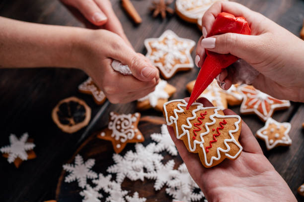 istock Friends decorating christmas gingerbread cookies 1177917443