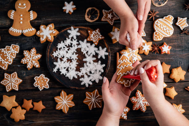 istock Friends decorating christmas gingerbread cookies 1177917449