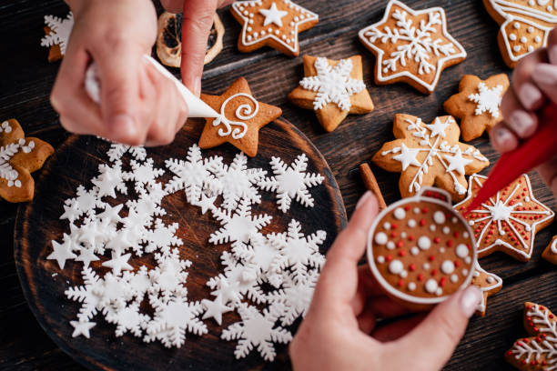 istock Friends decorating christmas gingerbread cookies 1177917897