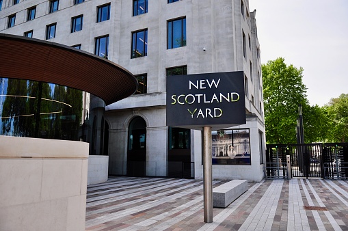London, England, UK – May 18, 2018: The entrance to New Scotland Yard boasts a beautifully modern sign against its 1930s Neoclassical home. It was redesigned when the force's headquarters was moved back to this Embankment location from their Broadway one.