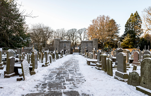 A view of the entrance stone gate to St Machar's Cathedral from inner cemetery in winter, Aberdeen, Scotland, December 2017. Photo was taken in the morning after unusual heavy snowfall in the city.