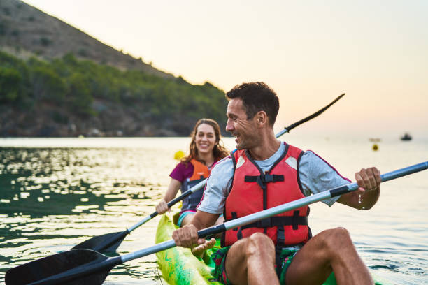 istock Man and woman talking while kayaking on river 1177929328
