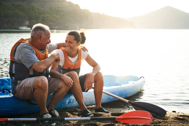 istock Father talking to daughter while sitting on kayak 1177929335