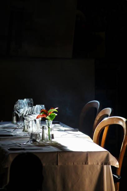 istock empty table of a restaurant set with a ray of light and smoke 1177930320