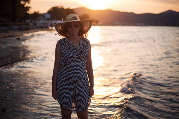 istock Woman walking on a beach 1177930968