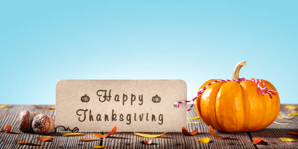 Mini Pumpkin With Greeting Tag On Wooden Table