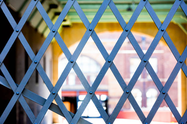 Closeup factory iron gate, background with copy space, full frame horizontal composition