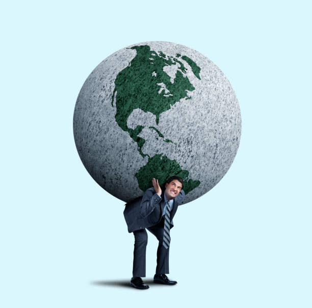 istock Businessman Struggles To Balance A Large Globe On His Back 1177934397