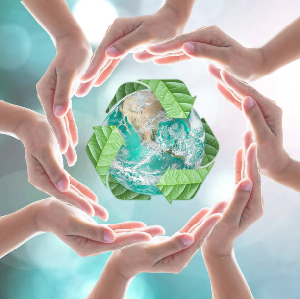 istock Hands surrounding green planet protected by recycle sign leaf on blurred bokeh .Elements of this image furnished by NASA 1177942796