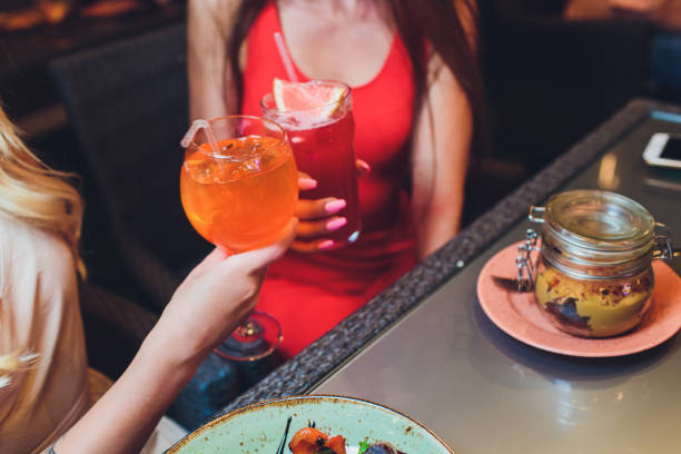 istock Human hands with glasses of red wine clinking them over served table. 1177943269