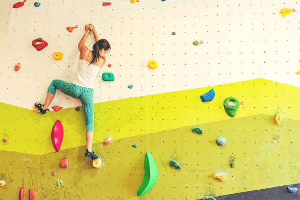 Woman in boulder gym.